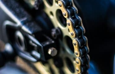 selective focus photography of gold sprocket